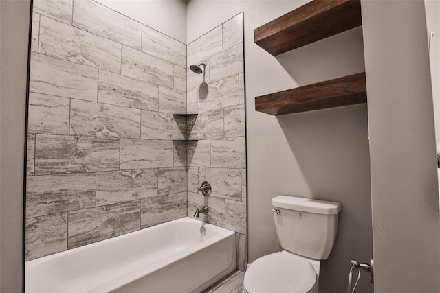 bathroom featuring toilet and tiled shower / bath