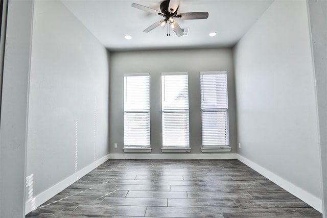 empty room featuring ceiling fan and dark hardwood / wood-style flooring