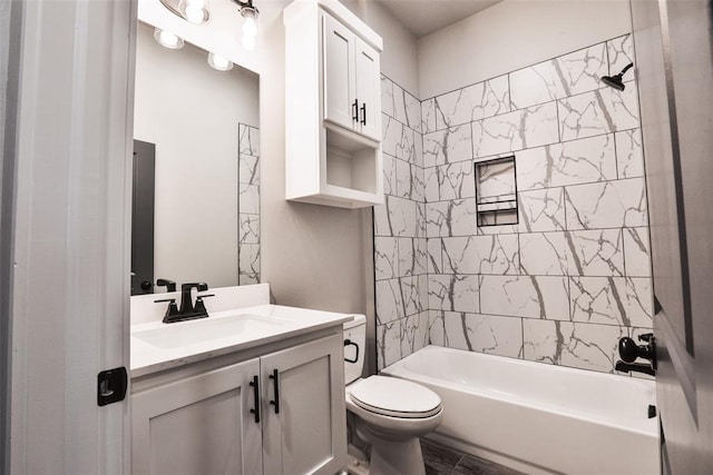 full bathroom with toilet, vanity, and tiled shower / bath