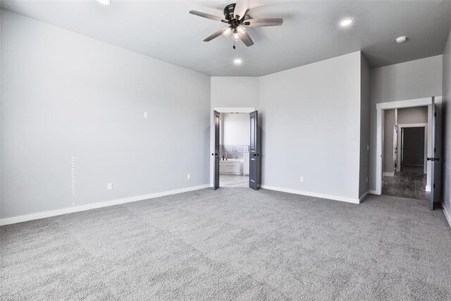 interior space featuring ensuite bath, ceiling fan, and carpet