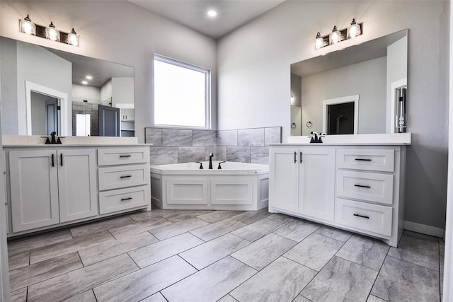 bathroom featuring separate shower and tub and vanity