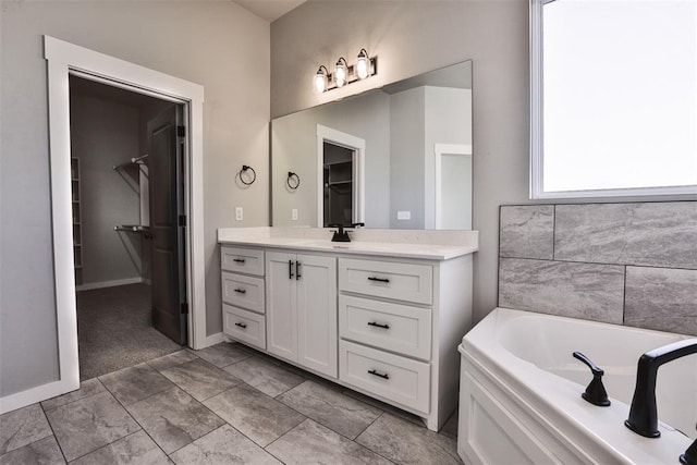 bathroom featuring vanity and a washtub