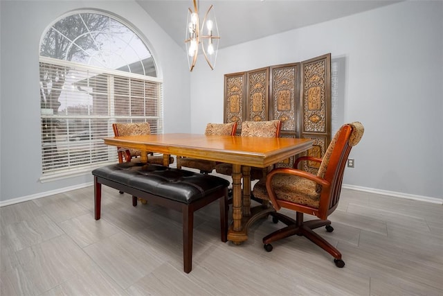 dining room with a chandelier and vaulted ceiling