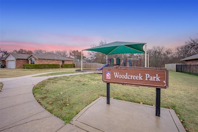 view of property's community with a yard and a playground