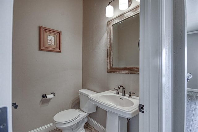 bathroom with hardwood / wood-style flooring and toilet