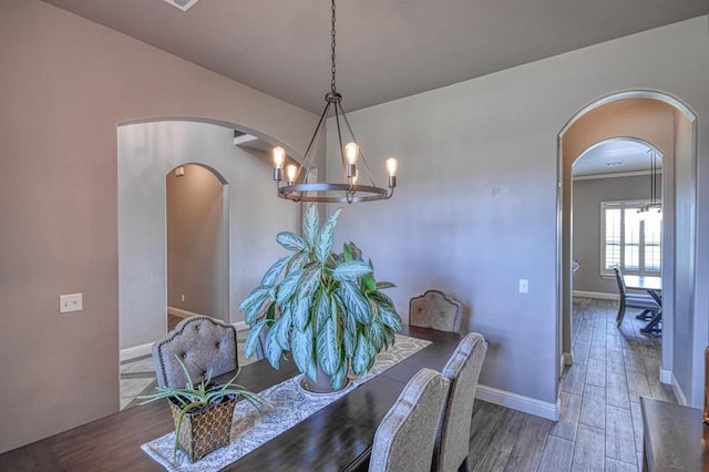 dining space with a chandelier and wood-type flooring