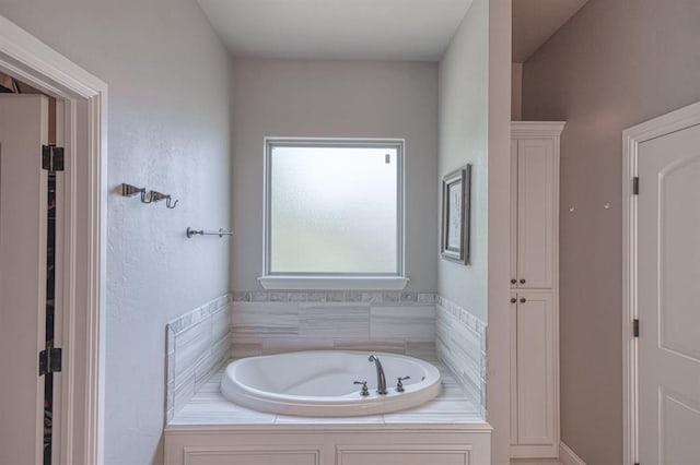 bathroom with tiled tub