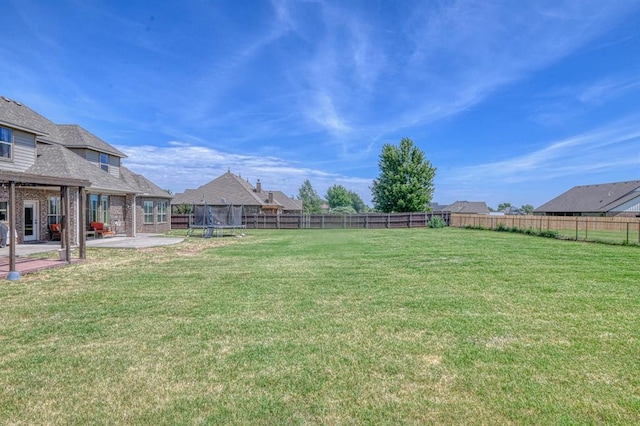 31814 Landrun Ave, Norman, OK 73072 - fenced backyard featuring a trampoline and a patio