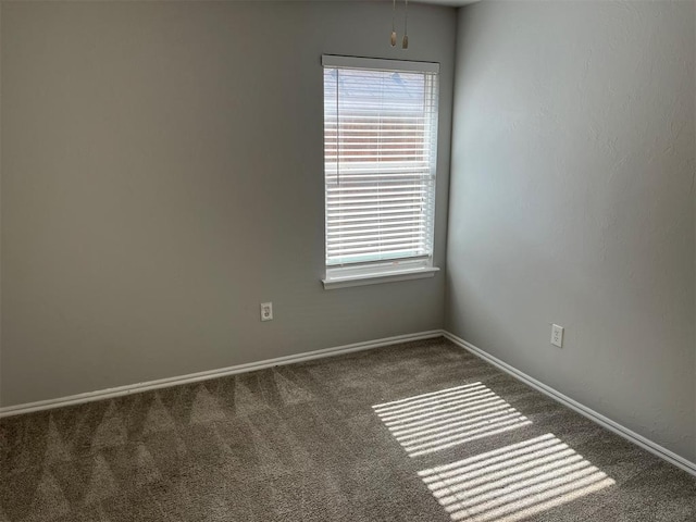 unfurnished room with dark carpet