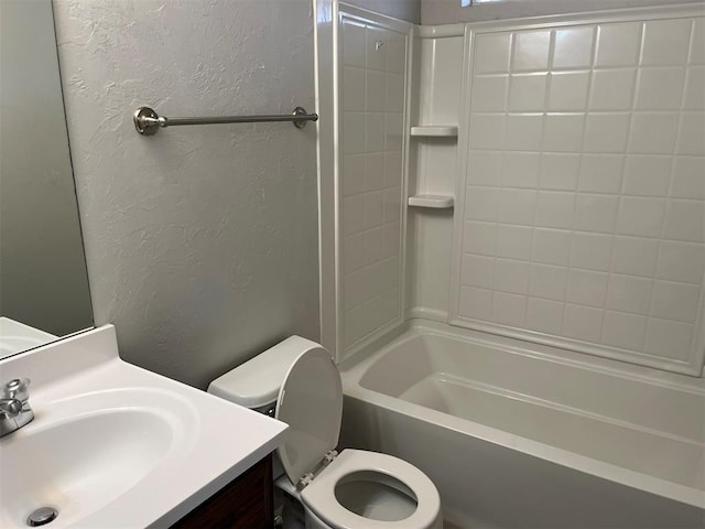 full bathroom featuring vanity, tiled shower / bath combo, and toilet