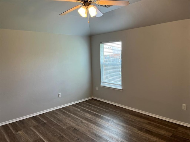 empty room with ceiling fan, lofted ceiling, and dark wood-type flooring