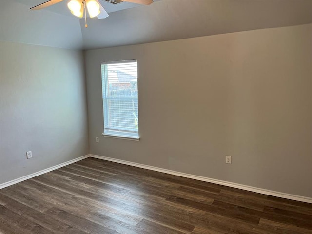 spare room with lofted ceiling, ceiling fan, and dark wood-type flooring