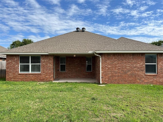 rear view of house with a patio area and a yard