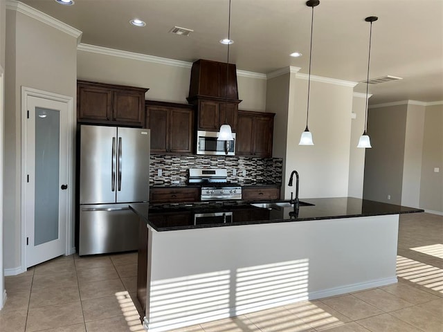 kitchen featuring sink, hanging light fixtures, stainless steel appliances, dark stone counters, and light tile patterned floors