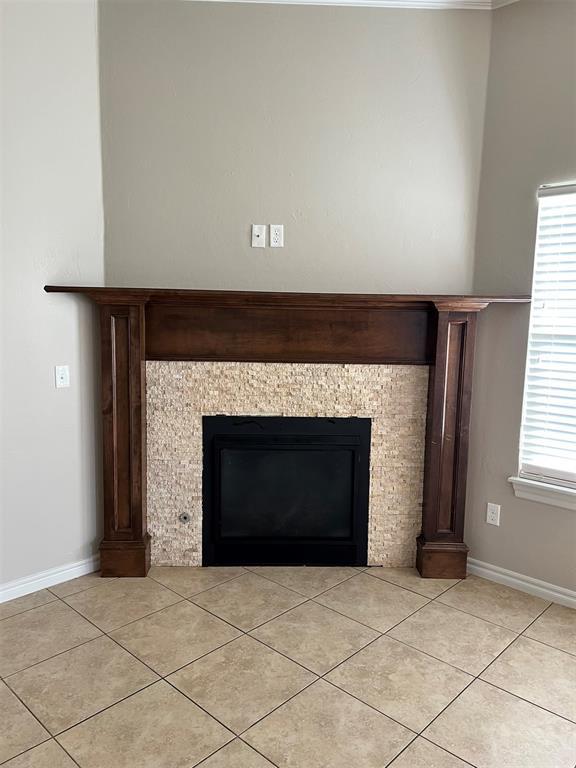 interior details with a tiled fireplace