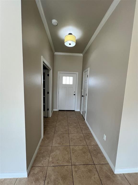 doorway with light tile patterned flooring and crown molding