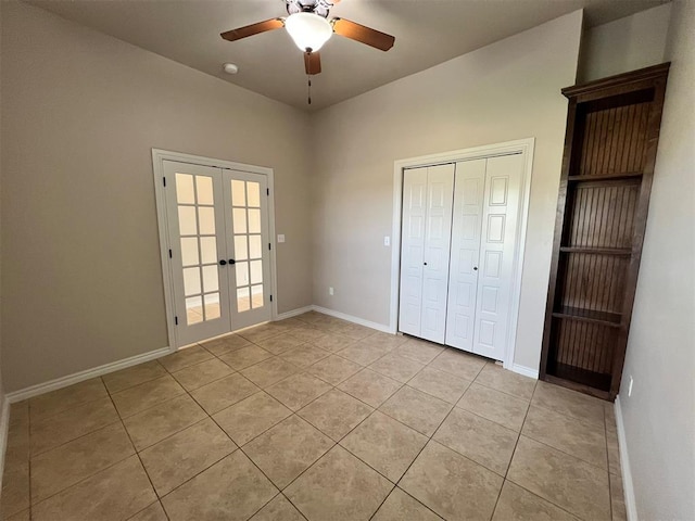 unfurnished bedroom featuring french doors, light tile patterned floors, a closet, and ceiling fan