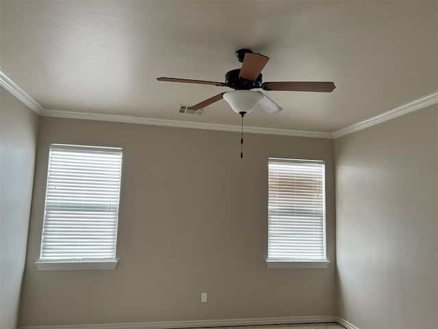 spare room featuring ceiling fan, a healthy amount of sunlight, and ornamental molding