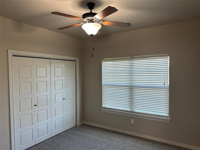 unfurnished bedroom with carpet flooring, ceiling fan, and a closet