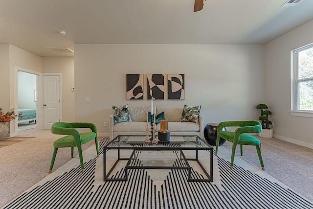 carpeted living room featuring ceiling fan