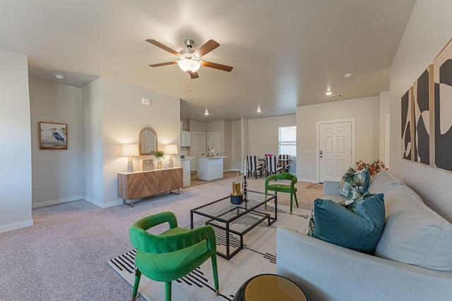 living room featuring light colored carpet and ceiling fan