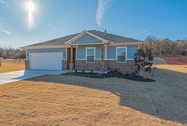 view of front of house featuring a garage and a front lawn