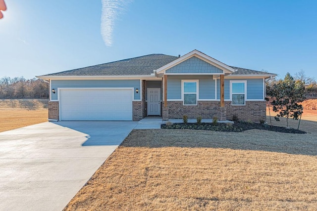 view of front of property with a front yard and a garage