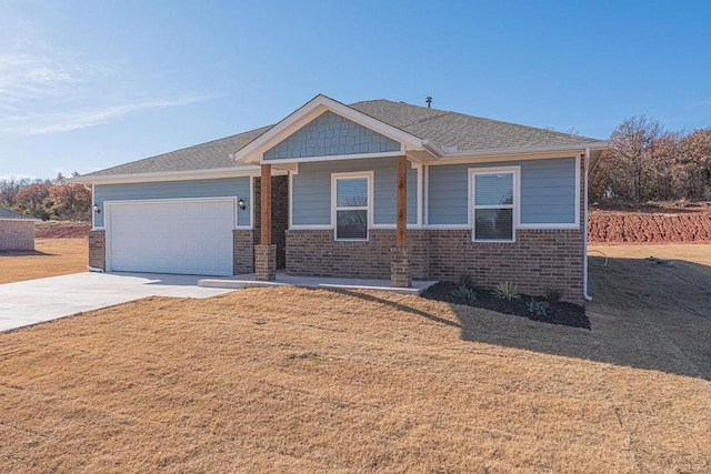 view of front of house with a garage and a front lawn