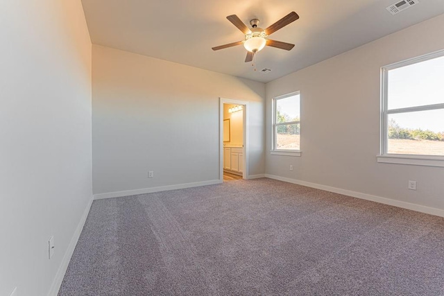 carpeted empty room featuring ceiling fan