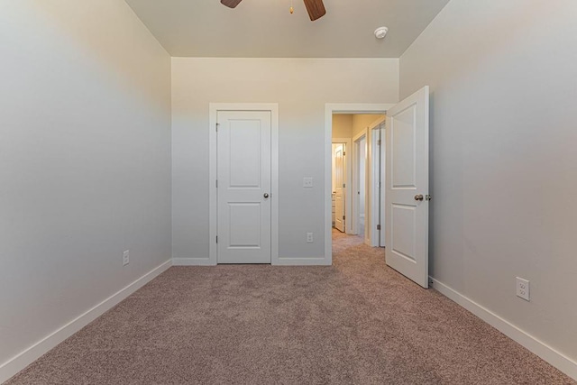 unfurnished bedroom with ceiling fan and light carpet