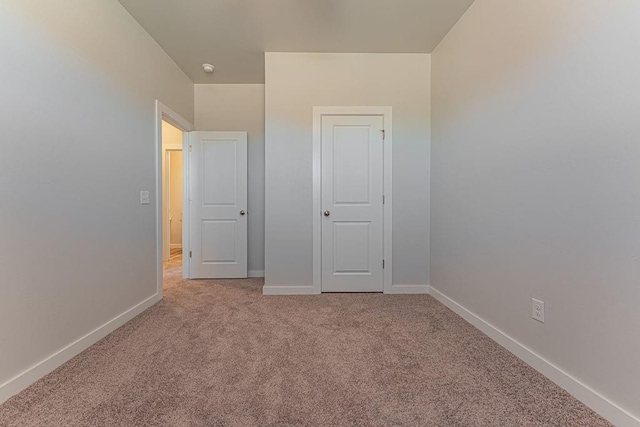 unfurnished bedroom featuring light colored carpet