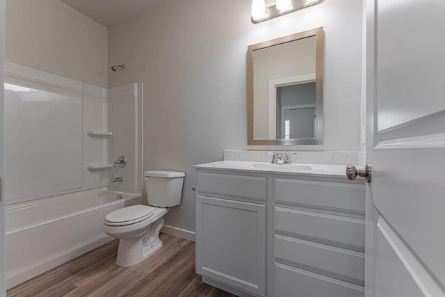 full bathroom featuring hardwood / wood-style flooring, toilet, vanity, and bathing tub / shower combination