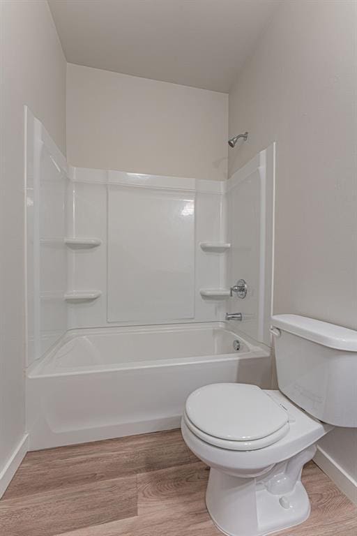 bathroom featuring toilet, bathtub / shower combination, and wood-type flooring