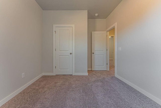 unfurnished bedroom featuring light carpet