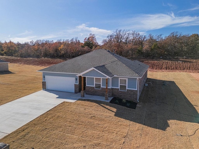 ranch-style house featuring a garage and a front yard