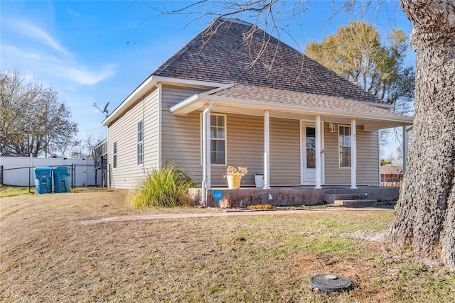 bungalow with covered porch and a front yard