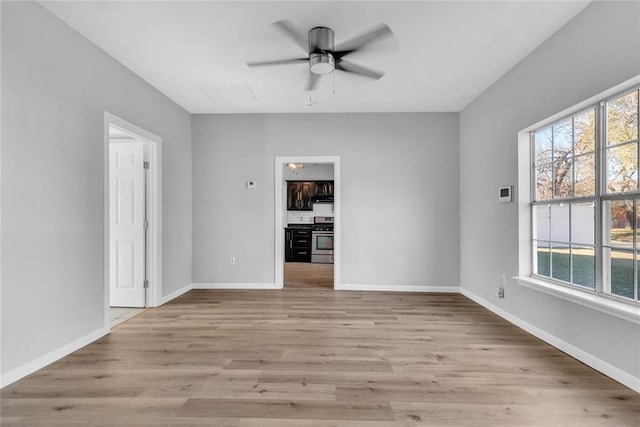 empty room featuring ceiling fan and light hardwood / wood-style flooring