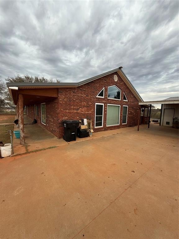 rear view of house featuring a carport