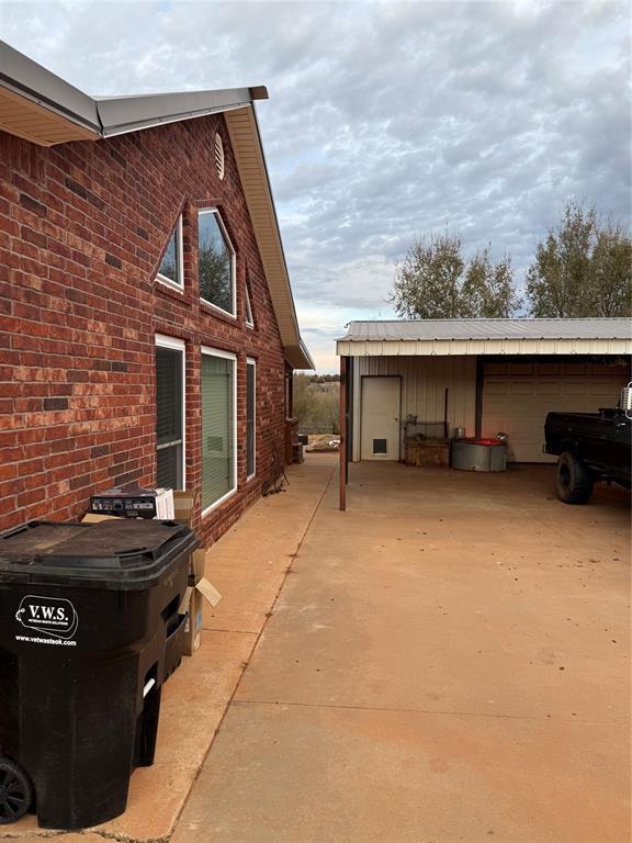 view of side of property with an outdoor structure and a garage