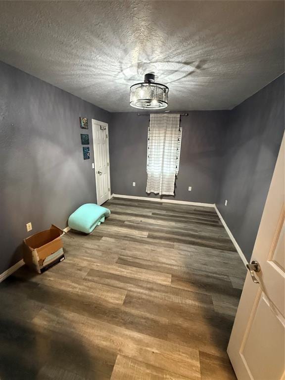 interior space with hardwood / wood-style flooring and a textured ceiling