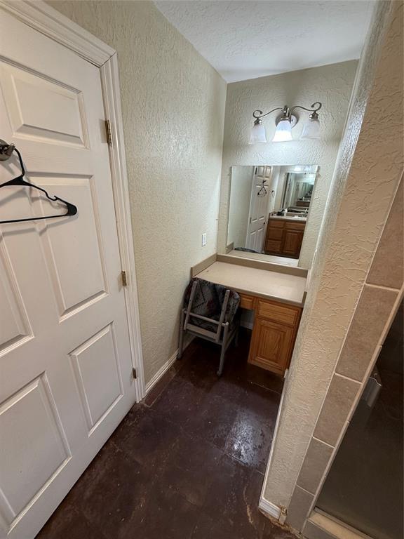 bathroom featuring a textured ceiling and vanity