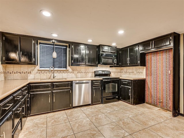 kitchen with sink, hanging light fixtures, tasteful backsplash, light tile patterned floors, and black appliances