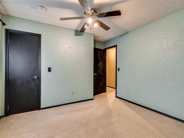 unfurnished bedroom with a textured ceiling and ceiling fan