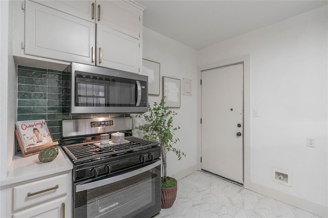 kitchen featuring stainless steel appliances and white cabinetry