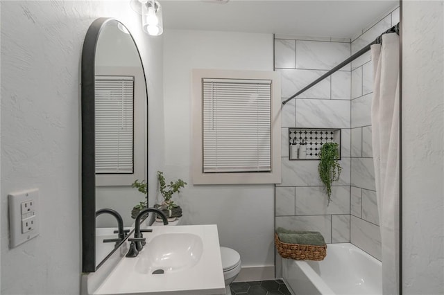 full bathroom featuring shower / bath combination with curtain, vanity, tile patterned floors, and toilet