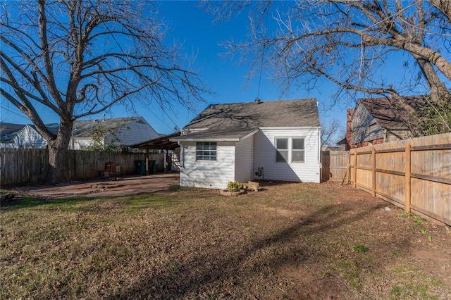 back of house featuring a yard and a patio area