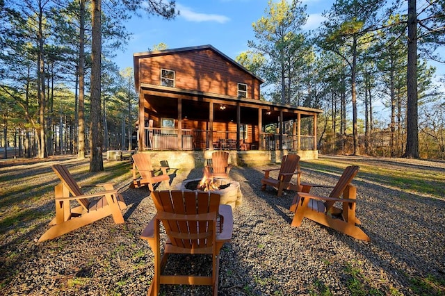 rear view of house with a fire pit