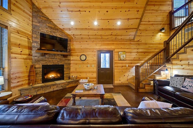 living room with wood walls, wood ceiling, a fireplace, and high vaulted ceiling