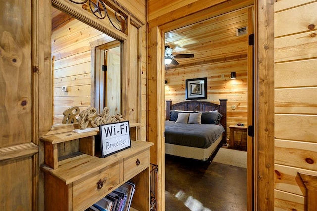 bedroom featuring dark carpet and wooden walls