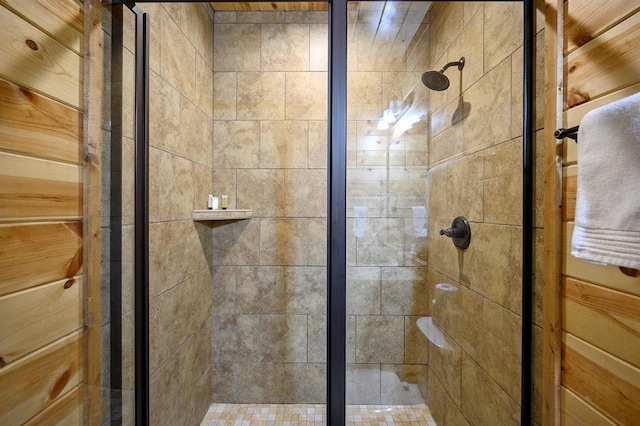 bathroom with a shower with door